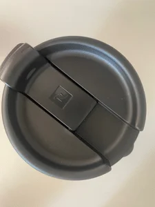 Photograph showing the lid of the nespresso touch travel mug with the latch closed.