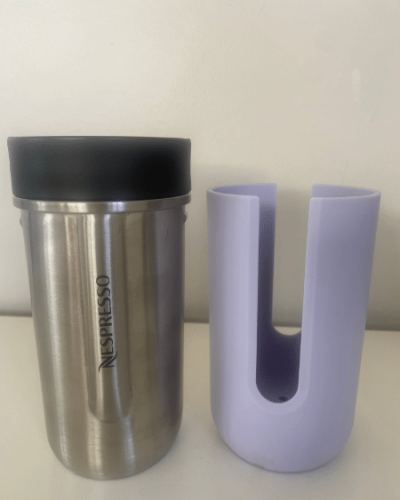 Photograph of Nespresso Nomad travel mug with colored sleeve removed.